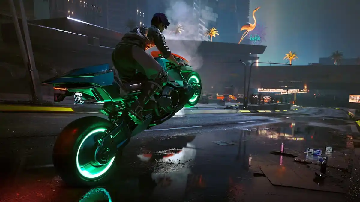 A female popping a wheelie down an empty street In Cyberpunk 2077.