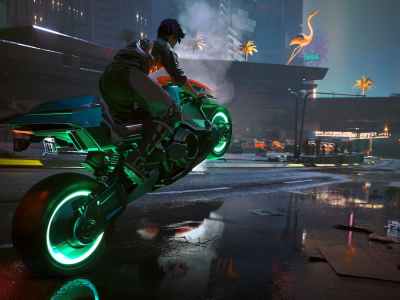 A female popping a wheelie down an empty street In Cyberpunk 2077.